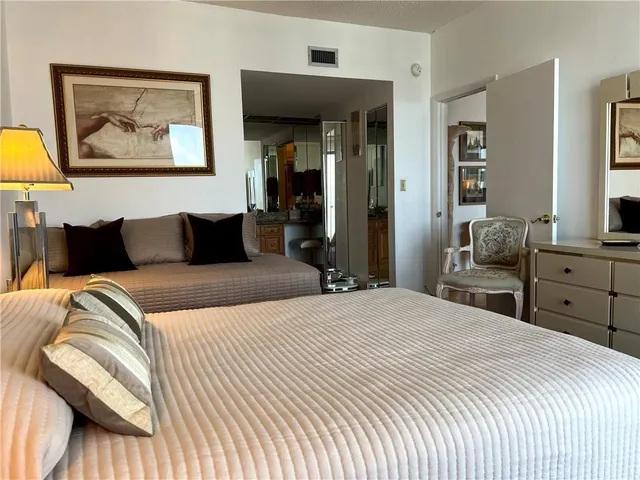 a bedroom with furniture and a large window