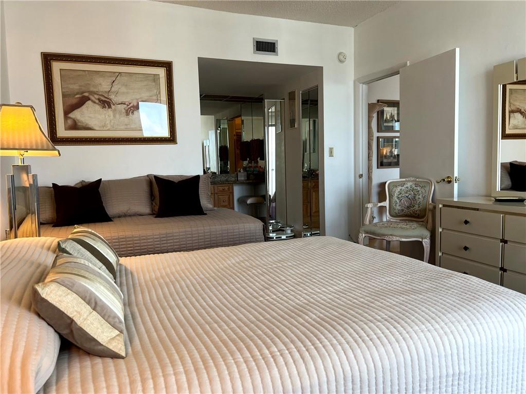 1010 South Ocean Boulevard, Unit PH12 Pompano Beach, FL 33062 - Photo 18 of 47 a bedroom with a bed and wooden floor