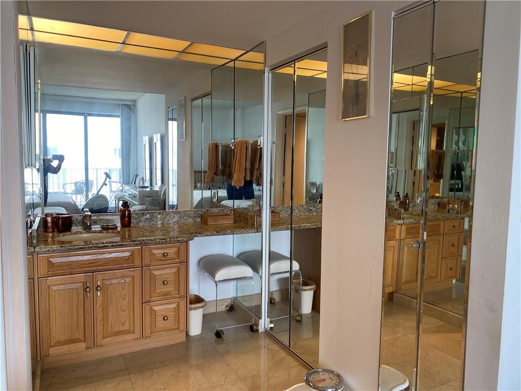 1010 South Ocean Boulevard, Unit PH12 Pompano Beach, FL 33062 - Photo 20 of 47 a bathroom with a sink a mirror and a shower