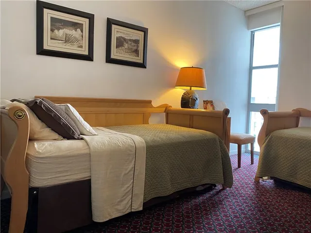 a bedroom with bed and window