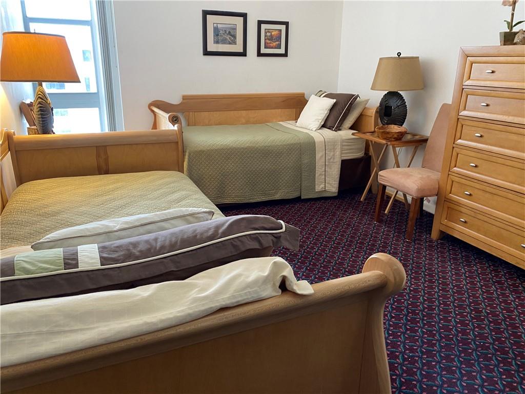 1010 South Ocean Boulevard, Unit PH12 Pompano Beach, FL 33062 - Photo 25 of 47 a bedroom with a bed and lamp