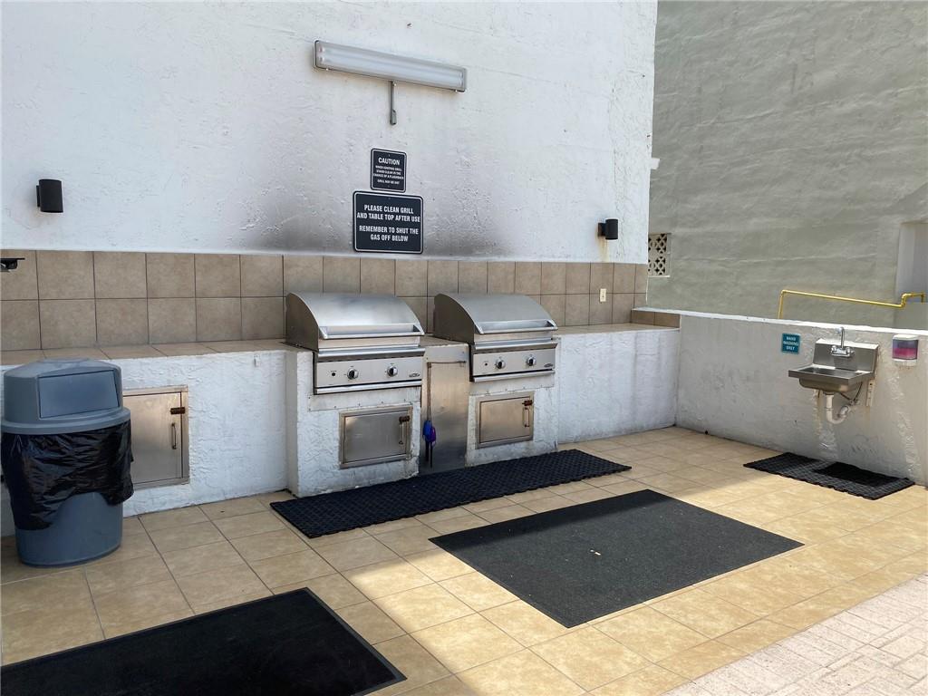 1010 South Ocean Boulevard, Unit PH12 Pompano Beach, FL 33062 - Photo 35 of 47 a kitchen with a stove and a cabinet