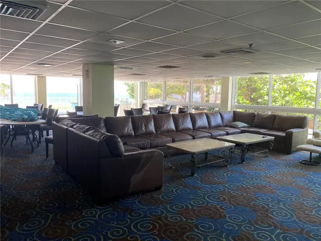 a room with pool table and windows