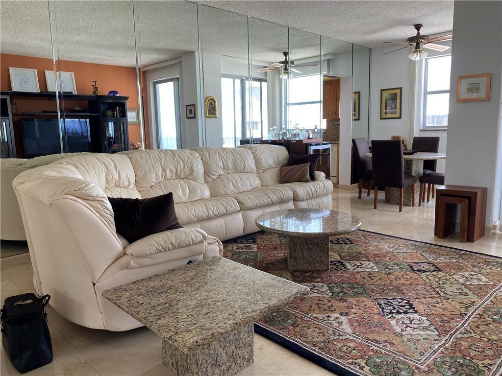 1010 South Ocean Boulevard, Unit PH12 Pompano Beach, FL 33062 - Photo 5 of 47 a living room with furniture and a chandelier