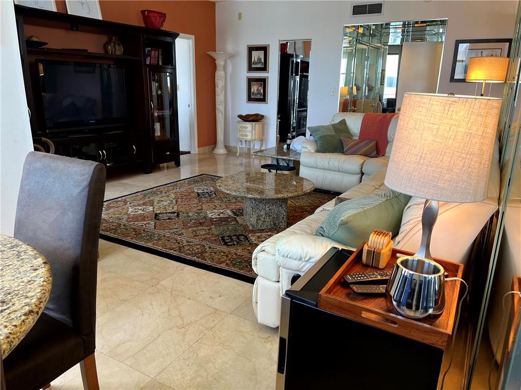 1010 South Ocean Boulevard, Unit PH12 Pompano Beach, FL 33062 - Photo 8 of 47 a living room with furniture and a flat screen tv