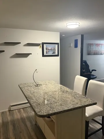a bedroom with a granite countertop sink and cabinets