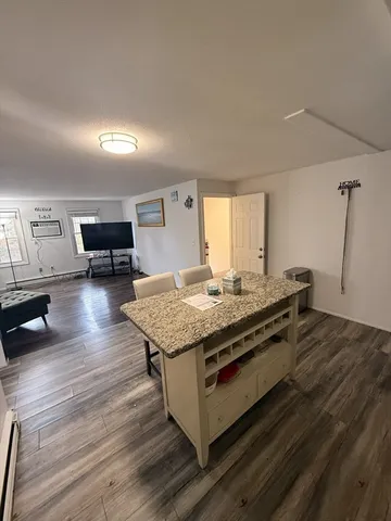 a living room with hard wood floors and a couch