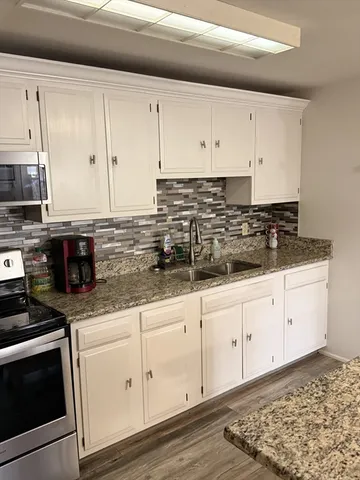 a kitchen with stainless steel appliances and wooden cabinets