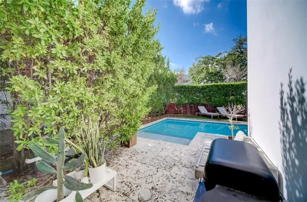 a bedroom with a bed and flat tv screen on the dresser