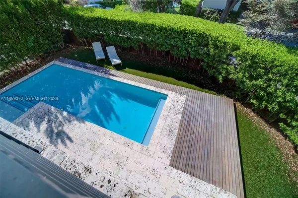 a bedroom with a bed and a lamp next to a large window