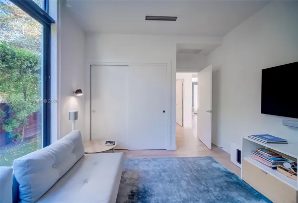 a kitchen with a sink white cabinets and stainless steel appliances