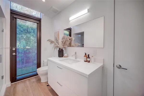 a kitchen with sink and white cabinets