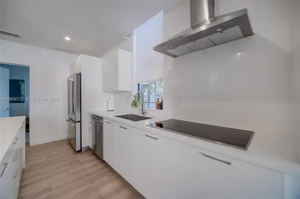 a bathroom with a sink a mirror and a bath tub