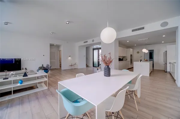 a living room with furniture tv and large windows