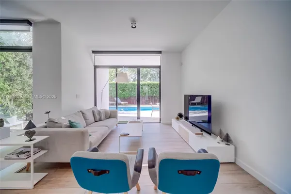 a view of a hallway with entryway wooden floor and front door