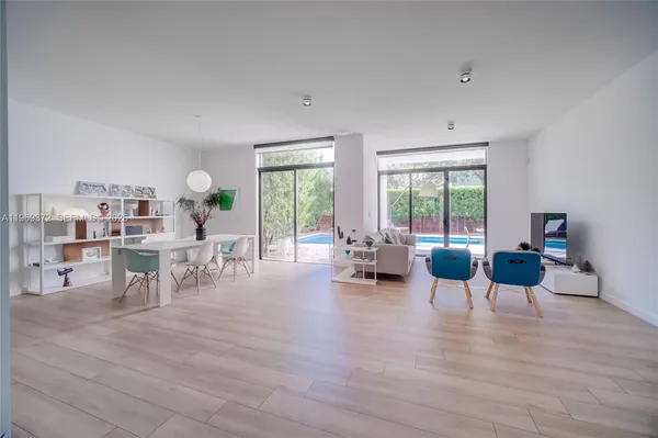 a view of a room with wooden floor and furniture