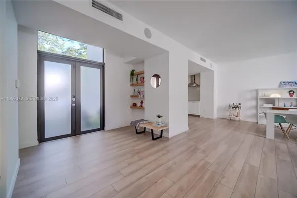 a backyard with potted plants and brick wall