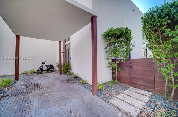 a view of a chair and table in backyard of the house