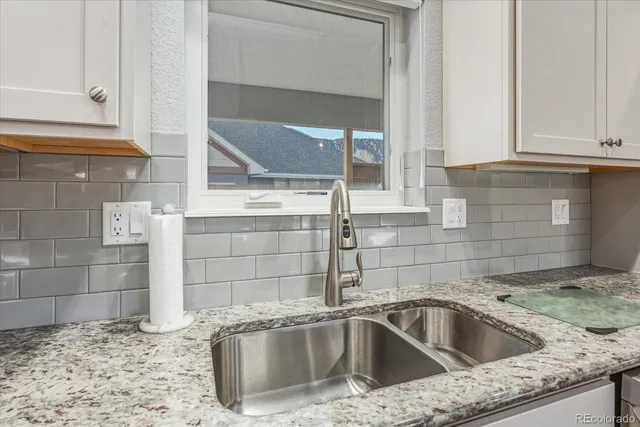 a kitchen with stainless steel appliances kitchen island granite countertop a stove a sink and a refrigerator