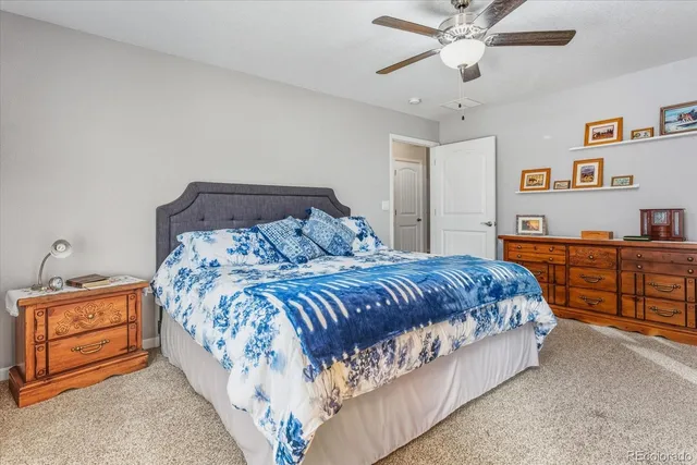 a bedroom with a bed and dresser with mirror