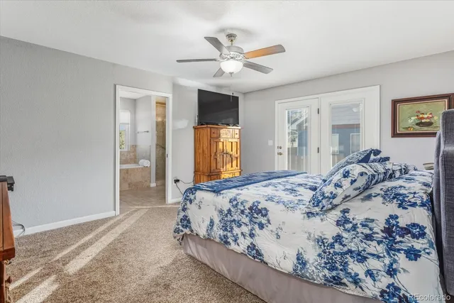 a bathroom with a granite countertop tub sink and mirror