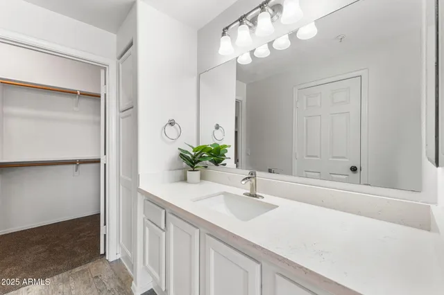 a bathroom with a sink a vanity and a mirror