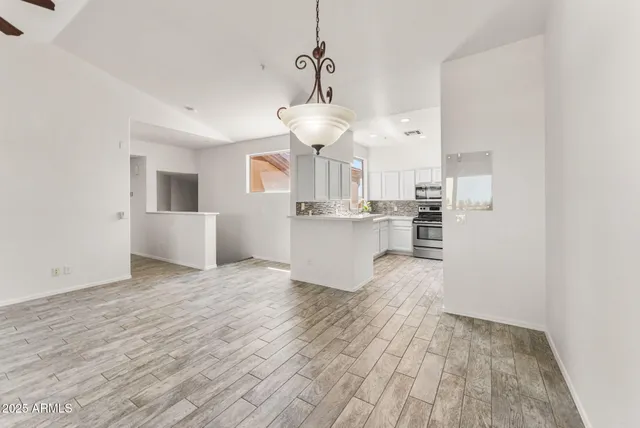 a view of kitchen and hall with wooden floor