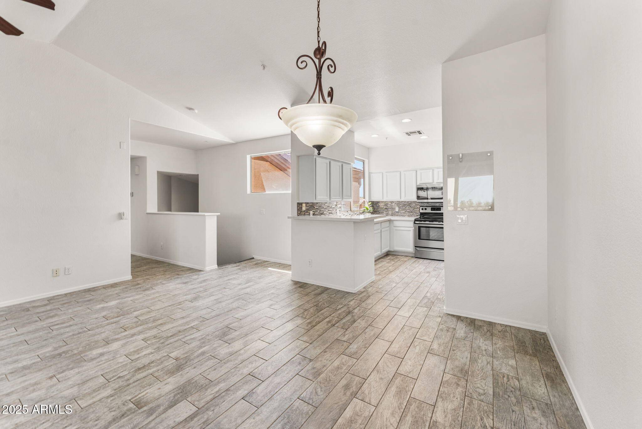 1445 East Broadway Road, Unit 208 Tempe, AZ 85282 - Photo 3 of 18 a view of kitchen and hall with wooden floor