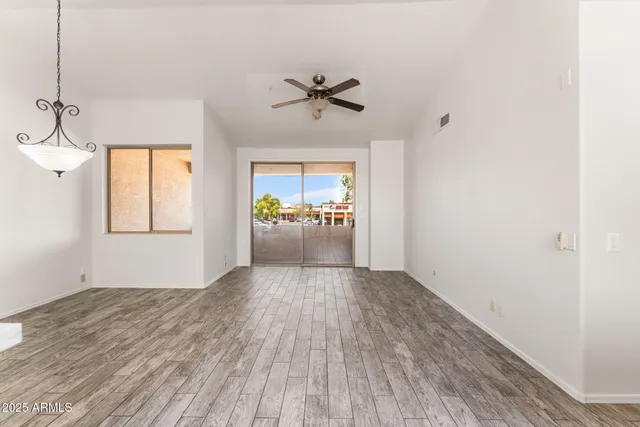 a view of a livingroom with a ceiling fan and window