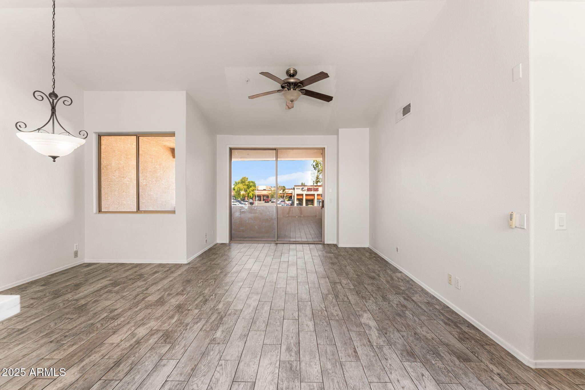 1445 East Broadway Road, Unit 208 Tempe, AZ 85282 - Photo 4 of 18 a view of a livingroom with a ceiling fan and window
