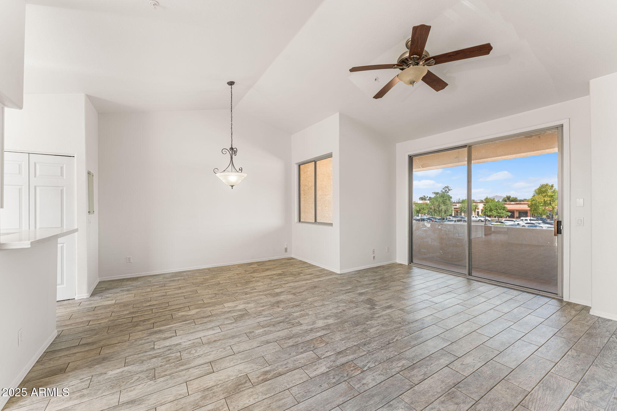 1445 East Broadway Road, Unit 208 Tempe, AZ 85282 - Photo 5 of 18 a view of empty room with wooden floor and fan