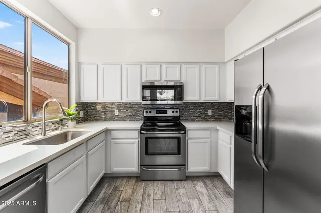 a kitchen with a stove a sink and a refrigerator