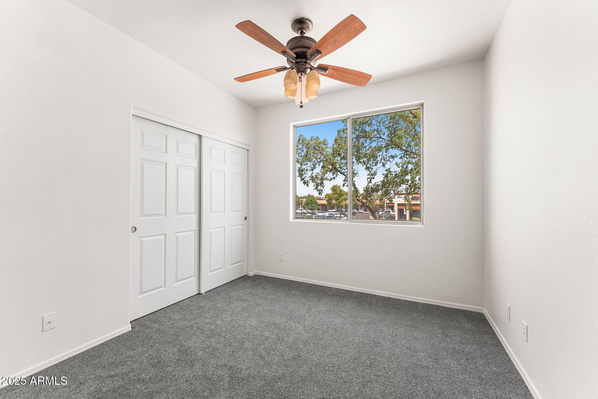 1445 East Broadway Road, Unit 208 Tempe, AZ 85282 - Photo 10 of 18 an empty room with a window and a fan