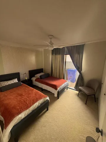 a bathroom with a sink a toilet a mirror and shower