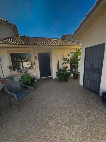 a view of a porch with furniture and a garage