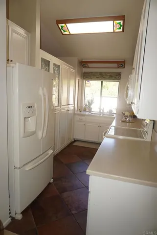 a kitchen with stainless steel appliances a refrigerator and a stove