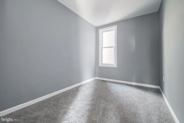 a view of an empty room with a fireplace