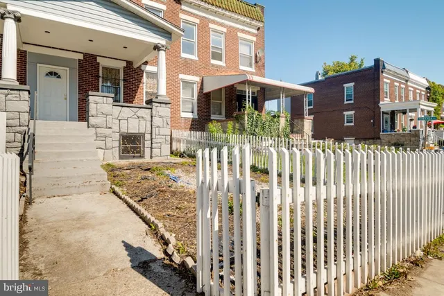 a view of a house with wooden fence