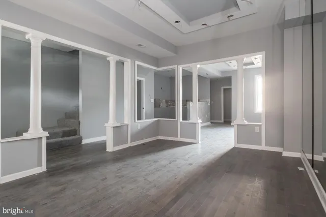 an empty room with windows and entrance