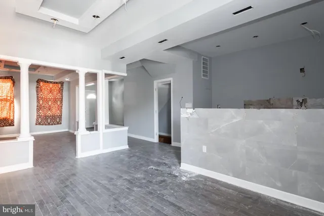 a view of a big room with windows and chandelier