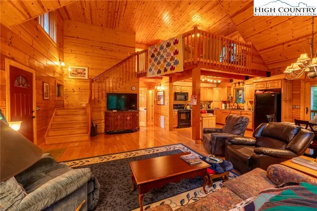 a bedroom with a bed and a lamp on dresser