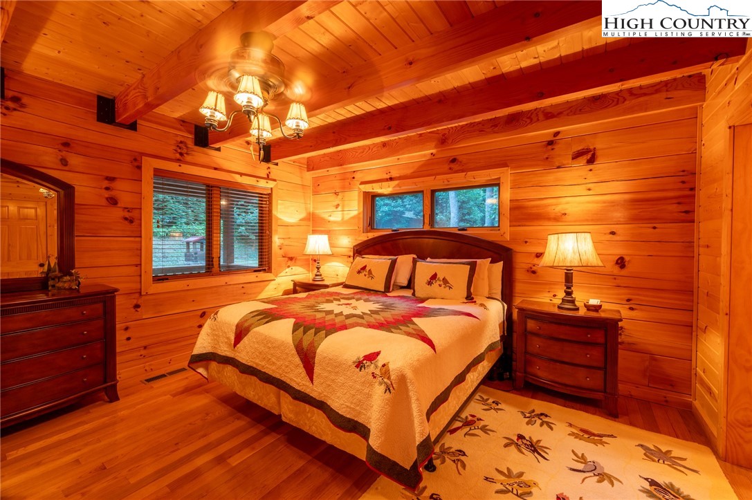 160 Capote Court Boone, NC 28607 - Photo 14 of 45 a bedroom with a bed and a lamp on dresser