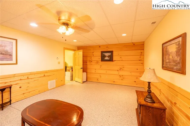 a spacious bedroom with a bed and wooden floor