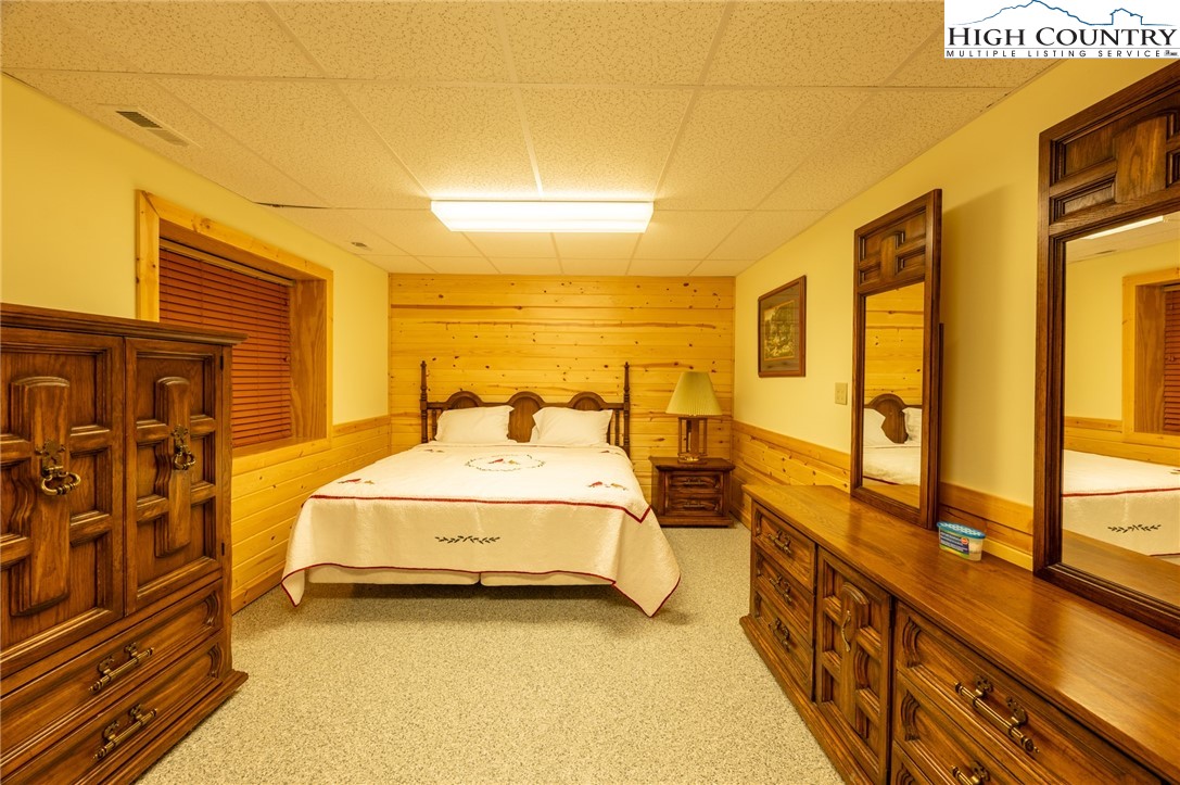 160 Capote Court Boone, NC 28607 - Photo 34 of 45 a spacious bedroom with a bed and wooden floor