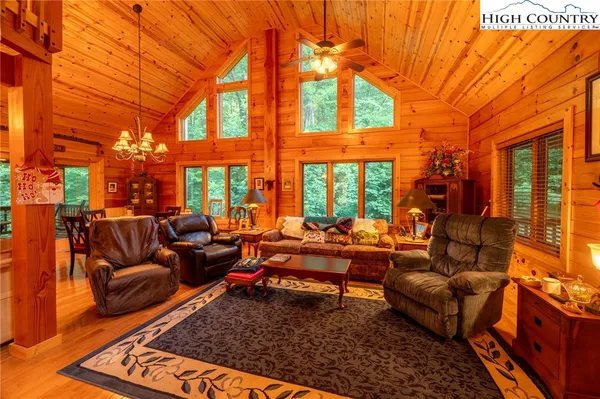 a living room with furniture a large window and a rug