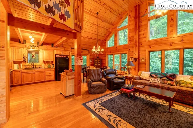 a living room with patio furniture and a floor to ceiling window