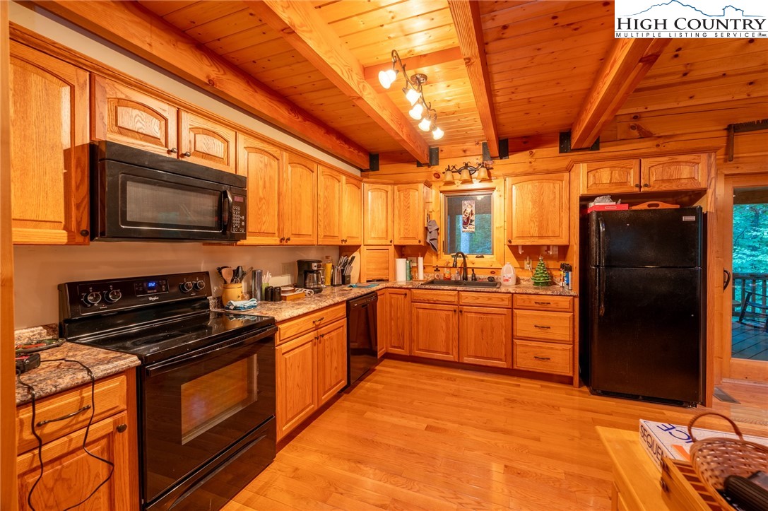 160 Capote Court Boone, NC 28607 - Photo 10 of 45 a kitchen with stainless steel appliances granite countertop a stove a sink and a refrigerator