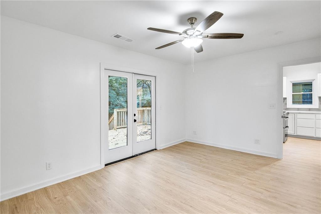 1967 Browns Mill Road Southeast Atlanta, GA 30315 - Photo 17 of 35 wooden floor in an empty room with a window