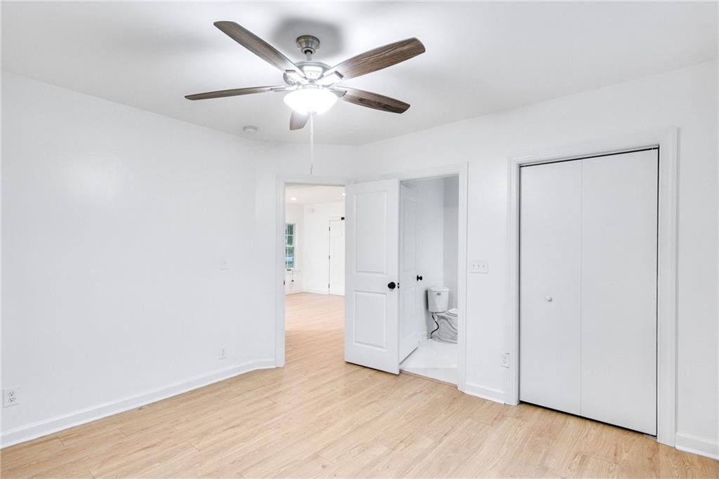 1967 Browns Mill Road Southeast Atlanta, GA 30315 - Photo 22 of 35 an empty room with wooden floor and windows