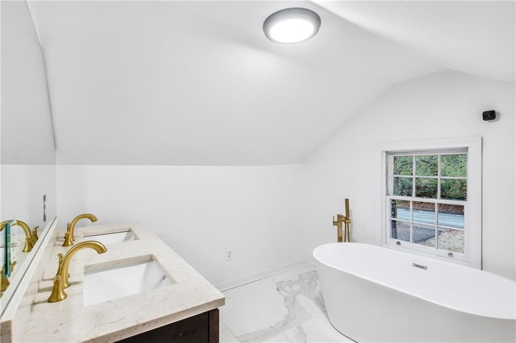 1967 Browns Mill Road Southeast Atlanta, GA 30315 - Photo 27 of 35 a bathroom with a sink and a bathtub